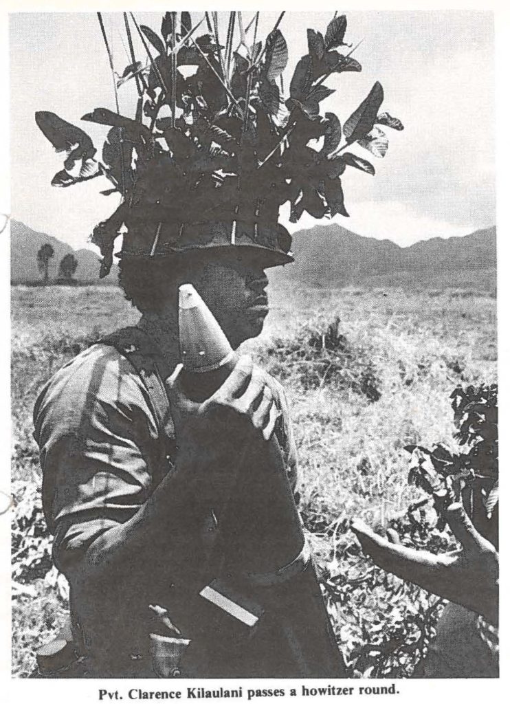 Pvt. Clarence Kilaulani passes a howitzer round.