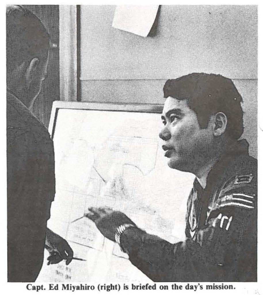 Capt. Ed Miyahiro (right) is briefed on the day's mission.