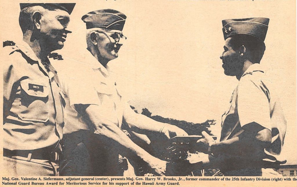 Maj. Gen. Valentine A. Siefermann, adjutant general (center), presents Maj. Gen. Harry W. Brooks, Jr., former commander of the 25th Infantry Division (right) with the National Guard Bureau Award for Meritorious Service for his support of the Hawaii Army Guard.