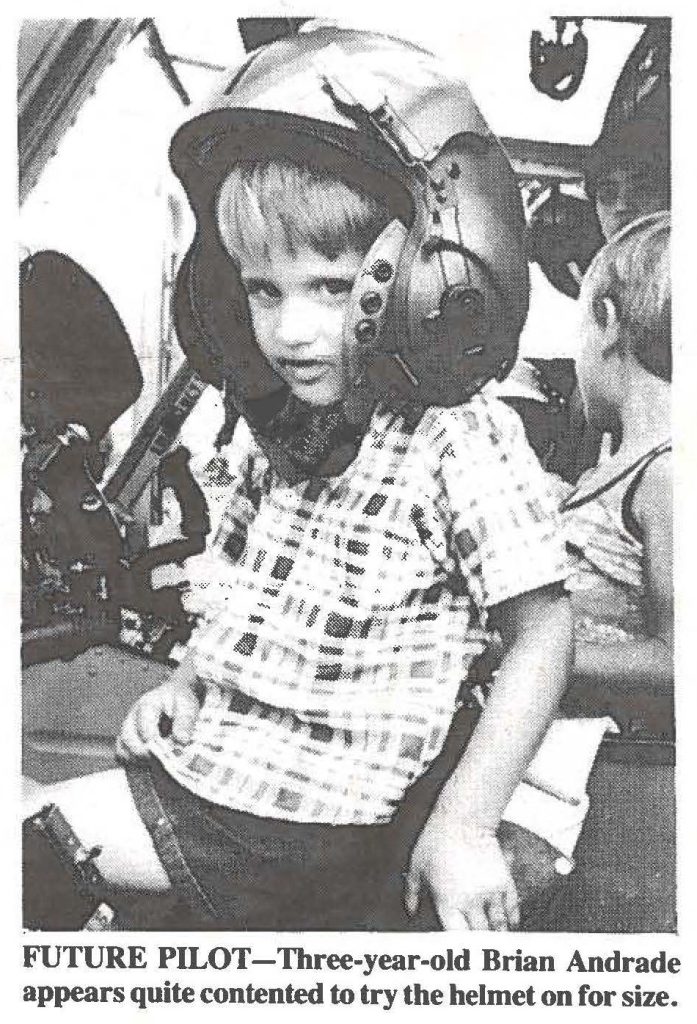 FUTURE PILOT-Three-year-old Brian Andrade appears quite contented to try the helmet on for size.