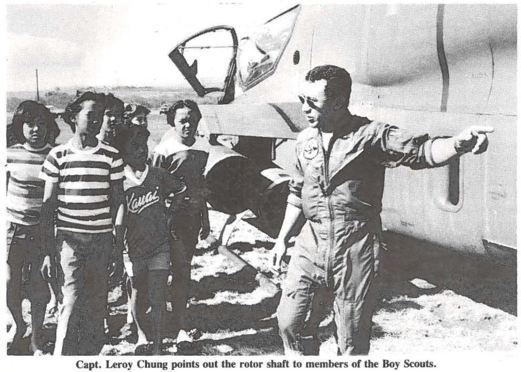 Capt. Leroy Chung points out the rotor shaft to members of the Boy Scouts.