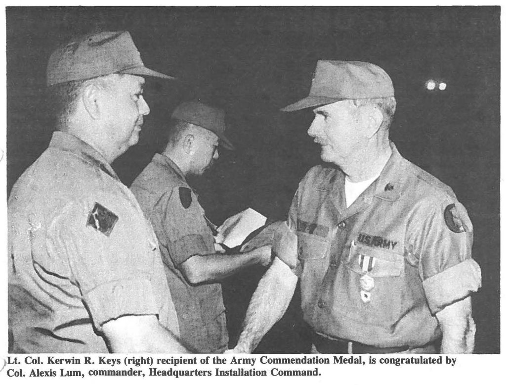 Lt. Col. Kerwin R. Keys (right) recipient of the Army Commendation Medal, is congratulated by Col. Alexis Lum, commander, Headquarters Installation Command.