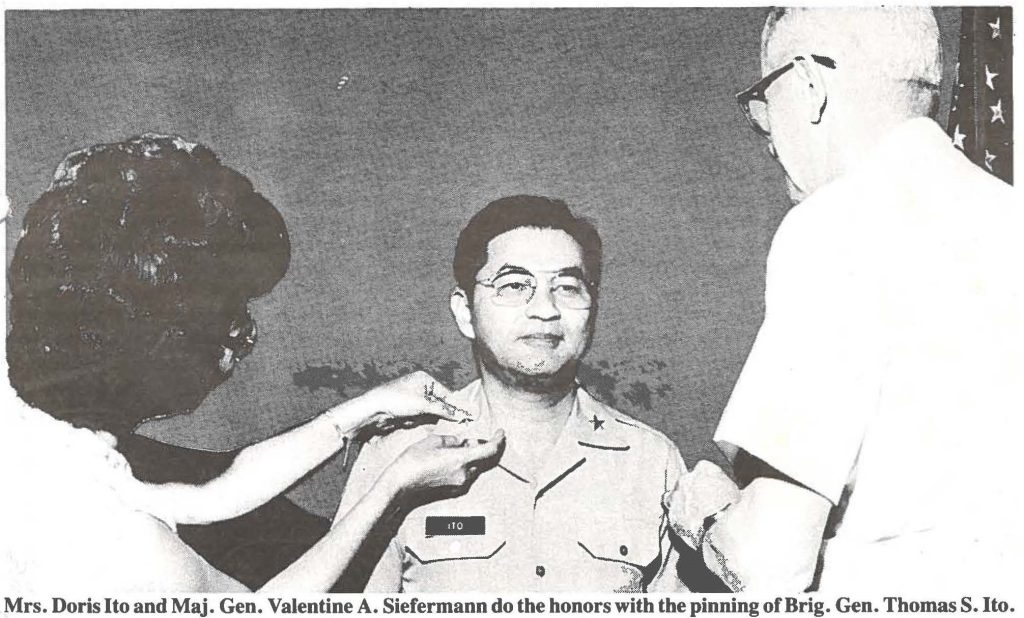 Mrs. Doris Ito and Maj. Gen. Valentine A. Siefermann do the honors with the pinning of Brig. Gen. Thomas S. Ito.