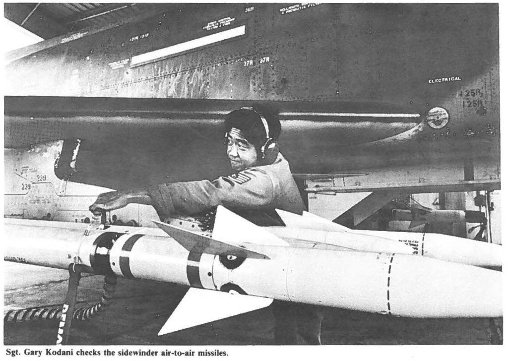 Sgt. Gary Kodani checks the sidewinder air-to-air missiles.