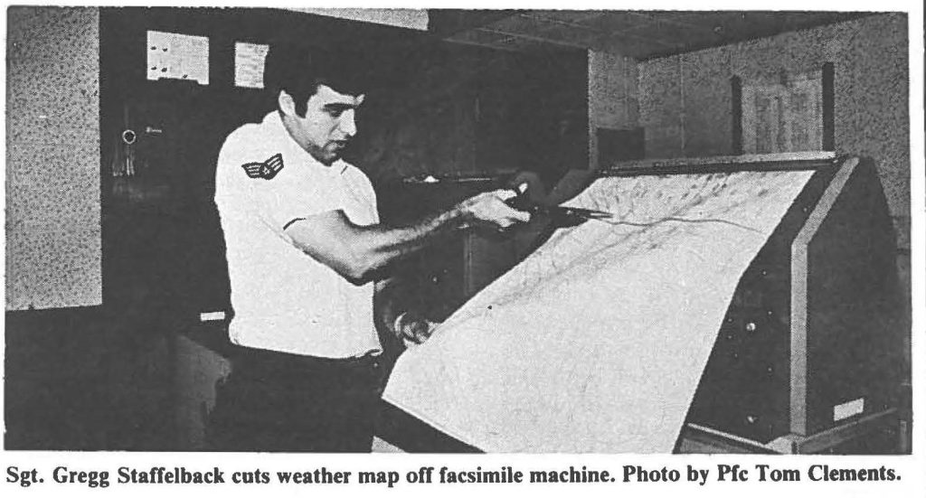 Sgt. Gregg Staffelback cuts weather map off facsimile machine. Photo by Pfc Tom Clements .