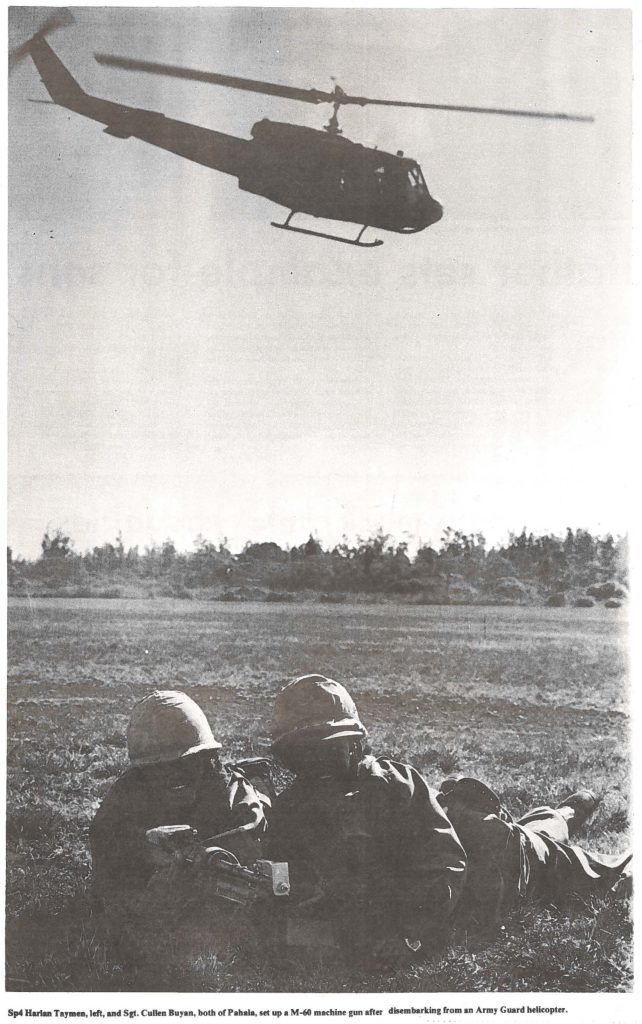 Sp4 Harlan Taymen, left, and Set. Cullen Buyan. both of Pahala, set up a M-60 machine gun after disembarking from an Army Guard helicopter.