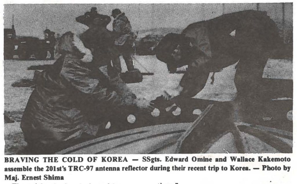 BRAVING THE COLD OF KOREA - SSgts. Edward Omine and Wallace Kakemoto assemble the 201st's TRC-97 anteMa reflector during their recent trip to Korea. - Photo by Maj. Ernest Shima