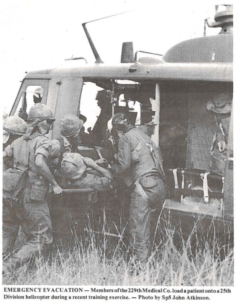 EMERGENCY EVACUATION - Members of the 229th Medical Co. load a patient onto a 25th Division helicopter during a recent training exercise. - Photo by SpS John Atkinson.