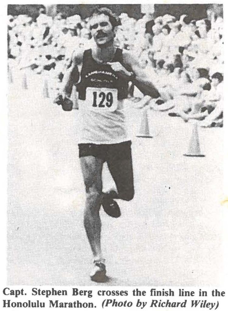 Capt. Stephen Berg crosses the finish line in the Honolulu Marathon. (Photo by Richard Wiley)