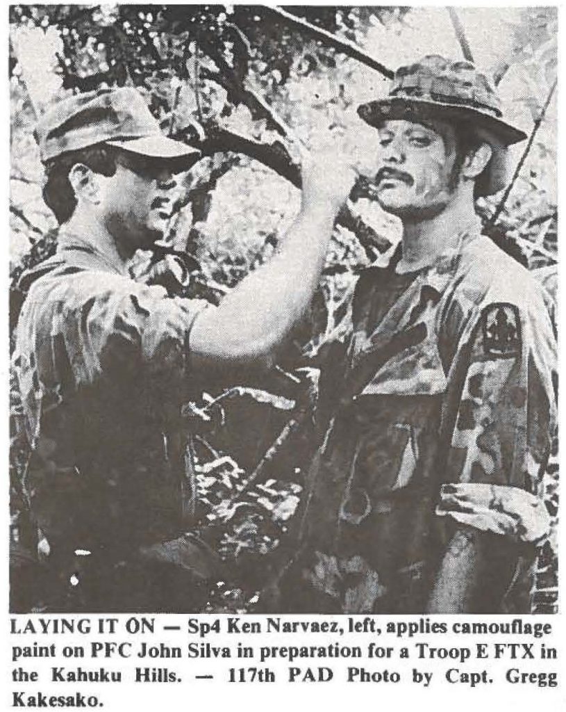 LAYING IT ON - Sp4 Ken Narvaez, left, applies camouflage paint on PFC John Silva in preparation for a Troop E FTX in the Kahuku Hills. - 117th PAD Photo by Capt. Gregg Kakesako.