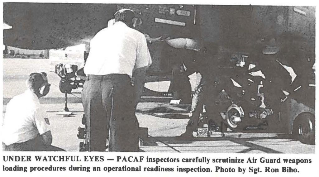 UNDER WATCHFUL EYES - PACAF inspectors carefully scrutinize Air Guard weapons loading procedures during an operational readiness inspection. Photo by Sgt. Ron Bibo.