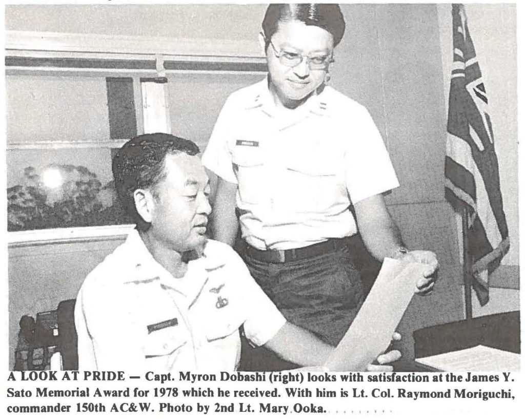 A LOOK AT PRIDE - Capt. Myron Dobashi (right) looks with satisfaction at the James Y. Sato Memorial Award for 1978 which he received. With him Is Lt. Col. Raymond Moriguchi, commander 150th AC&W. Photo by 2nd Lt. Mary Ooka.