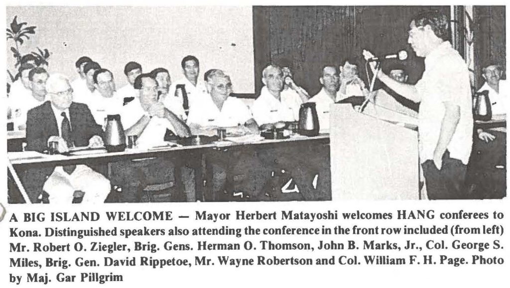 A BIG ISLAND WELCOME - Mayor Herbert Matayoshi welcomes HANG conferees to Kona. Distinguished speakers also attending the conference in the front row included (from left) Mr. Robert O. Ziegler, Brig. Gens. Herman 0. Thomson, John B. Marks, Jr., Col. George S. Miles, Brig. Gen. David Rippetoe, Mr. Wayne Robertson and Col. William F. H. Page. Photo by Maj. Gar Pillgrim