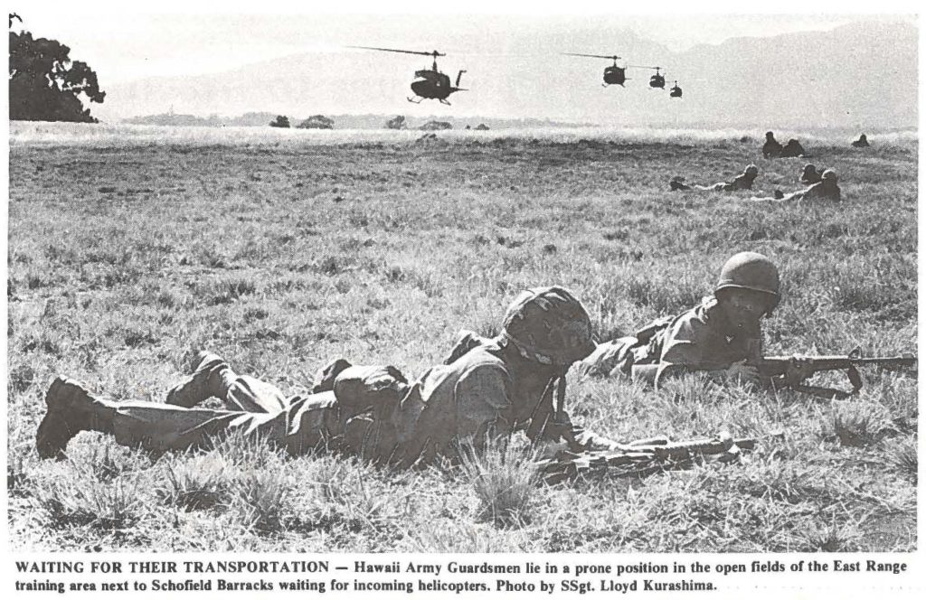 WAITING FOR THEIR TRANSPORTATION - Hawaii Army Guardsmen lie in a prone position in the open fields of the East Range training area next to Schofield Barracks waiting for incoming helicopters. Photo by SSgt. Lloyd Kurashima.