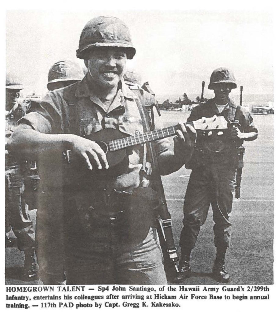 HOMEGROWN TALENT - Sp4 John Santiago, of the Hawaii Army Guard's 2/299th Infantry, entertains his colleagues after arriving at Hickam Air Force Base to begin annual training. - 117th PAD photo by Capt. Gregg K. Kakesako.