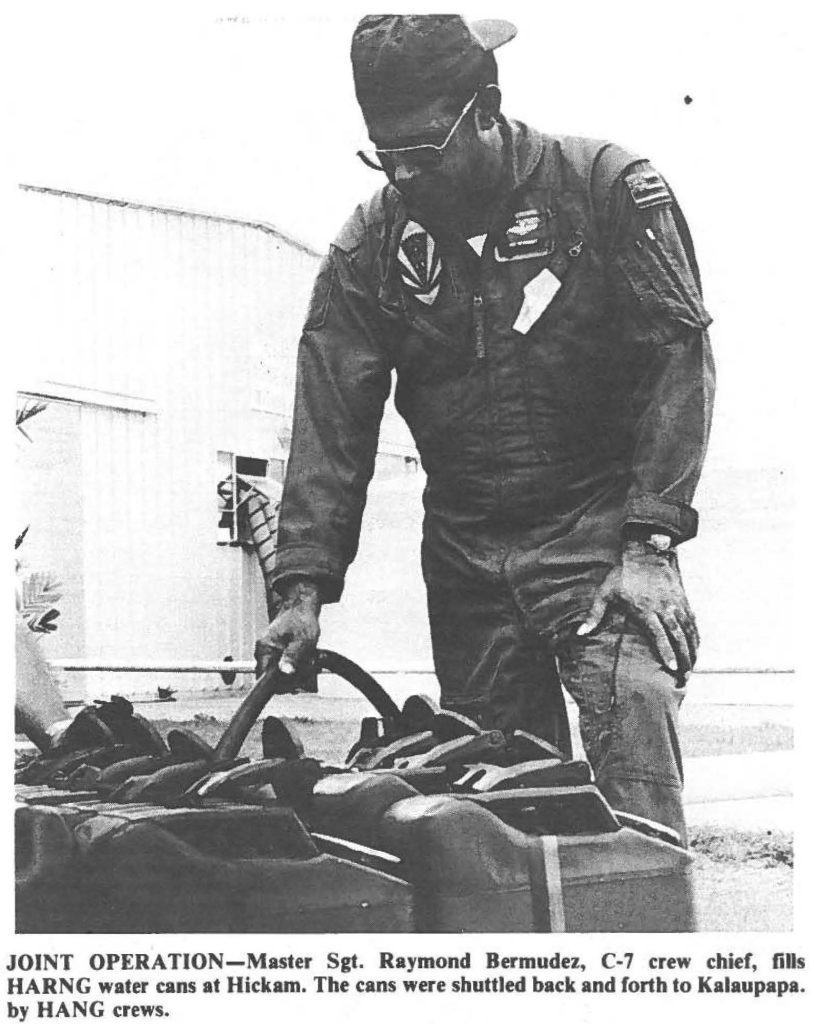 JOINT OPERATION-Master Sgt. Raymond Bermudez, C-7 crew chief, fills HARNG water cans at Hickam. The cans were shuttled back and forth to Kalaupapa. by HANG crews.