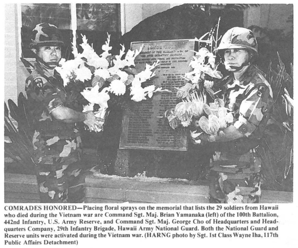 COMRADES HONORED-Placing floral sprays on the memorial that lists the 29 soldiers from Hawaii who died during the Vietnam war are Command Sgt. Maj. Brian Yamanaka (left) of the 100th Battalion, 442nd Infantry, U.S. Army Reserve, and Command Sgt. Maj. George Cho of Headquarters and Headquarters Company, 29th Infantry Brigade, Hawaii Army National Guard. Both the National Guard and Reserve units were activated during the Vietnam war. (HARNG photo by Sgt. 1st Class Wayne Iha, 117th Public Affairs Detachment)