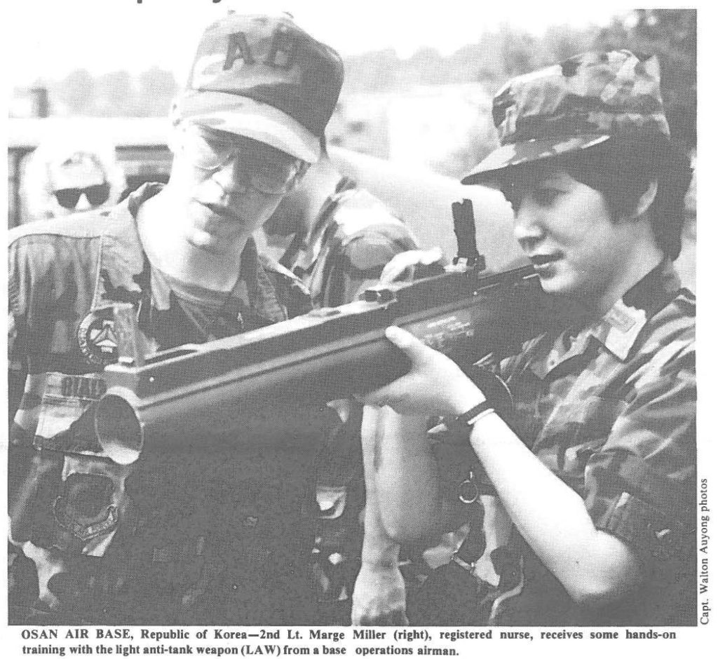 OSAN AIR BASE, Republic of Korea-2nd Lt. Marge Miller (right), registered nurse, receives some bands-on training with the light anti-tank weapon (LAW) from a base operations airman.