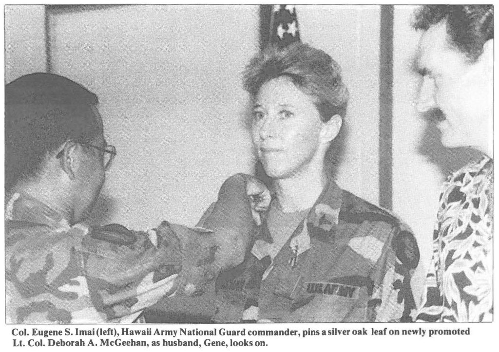 Col. Eugene S. Imai (left), Hawaii Army National Guard commander, pins a silver oak leaf on newly promoted Lt. Col. Deborah A. McGeehan, as husband, Gene, looks on.