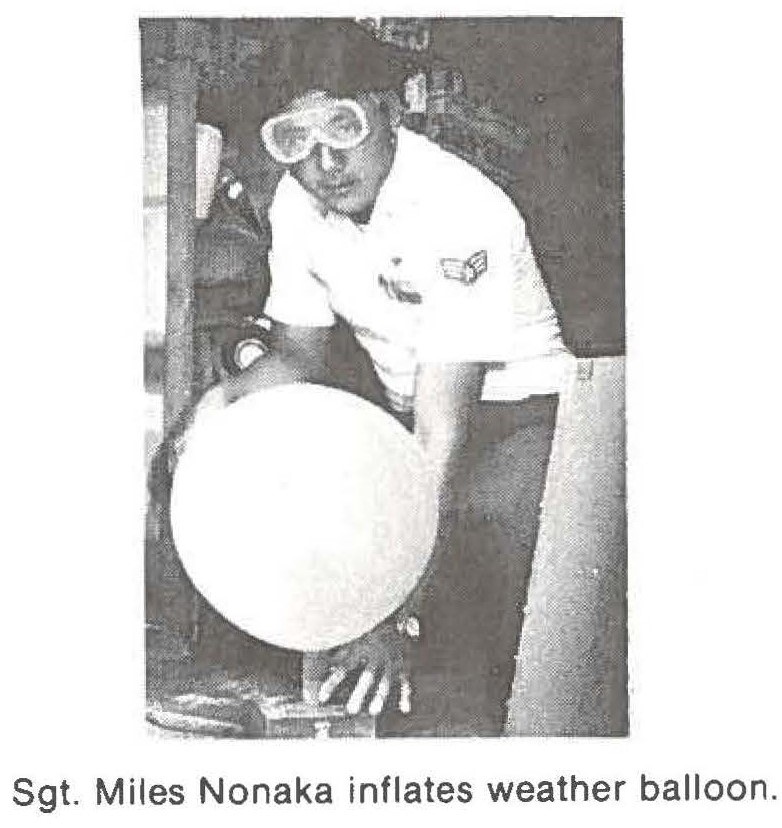 Sgt. Miles Nonaka inflates weather balloon.