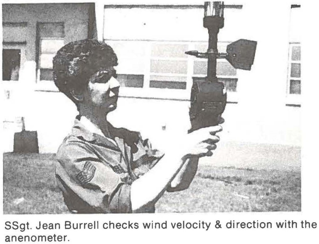 SSgt. Jean Burrell checks wind velocity & direction with the anenometer.