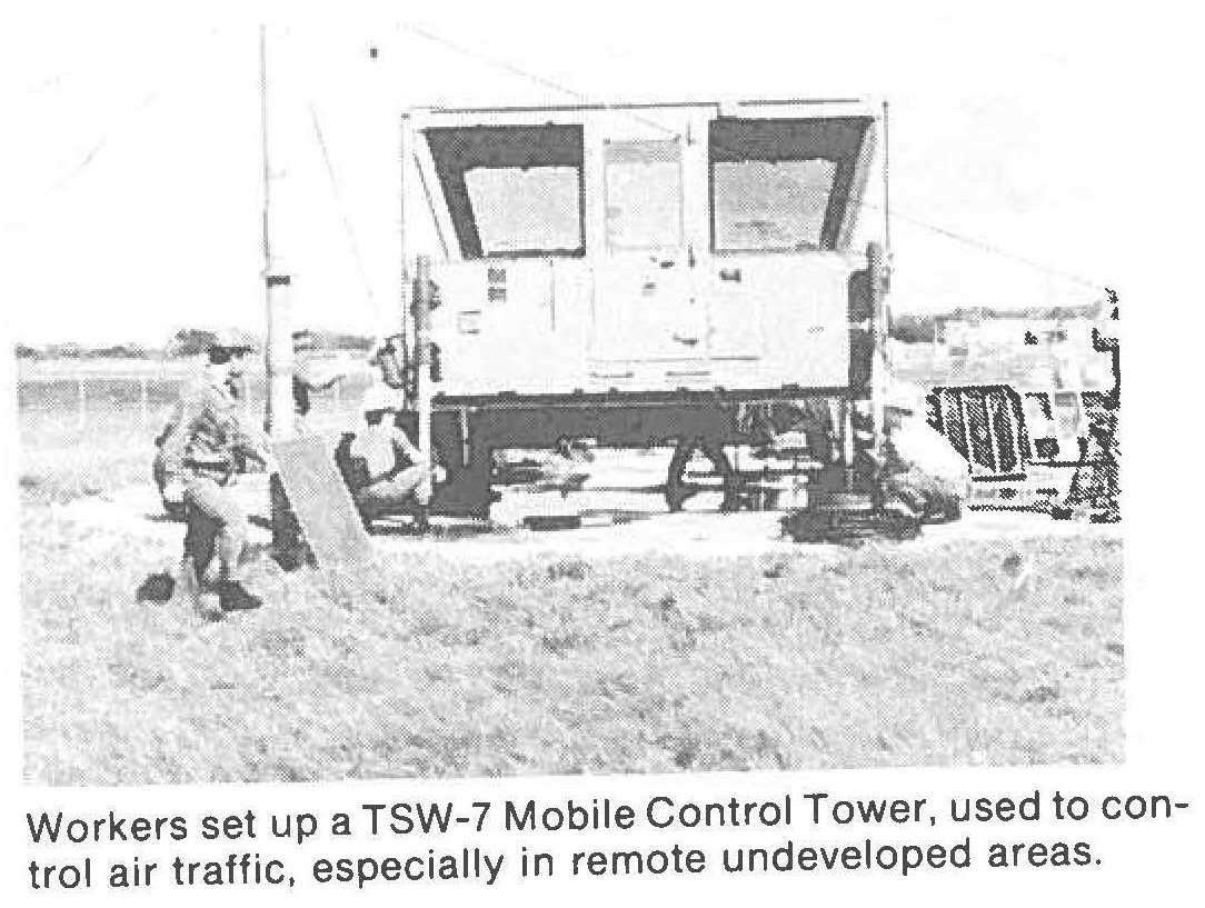 Workers set up a TSW-7 Mobile Control Tower, used to control air traffic, especially in remote undeveloped areas.