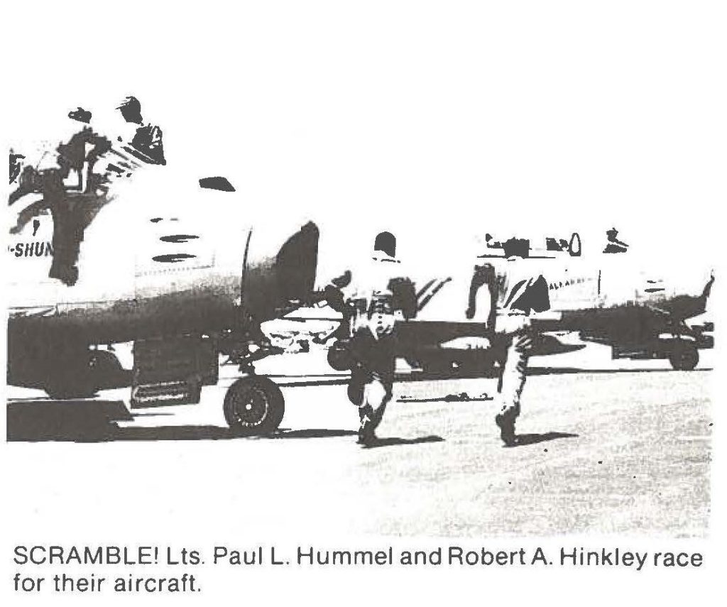 SCRAMBLE! Us. Paul L. Hummel and Robert A. Hinkley race for their aircraft.