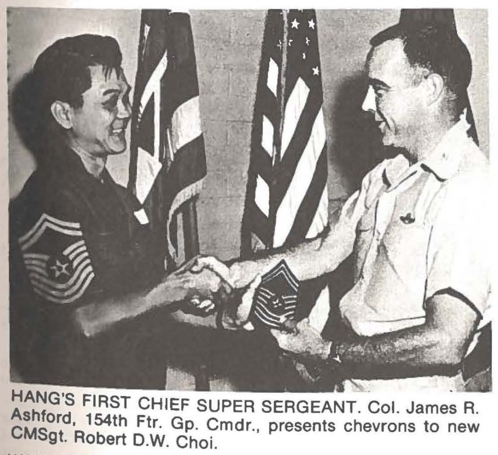 HANG's FIRST CHIEF SUPER SERGEANT. Col. James R. Ashford, 154th Ftr. Gp. Cmdr., presents chevrons to new CMSgt. Robert D.W. Choi.