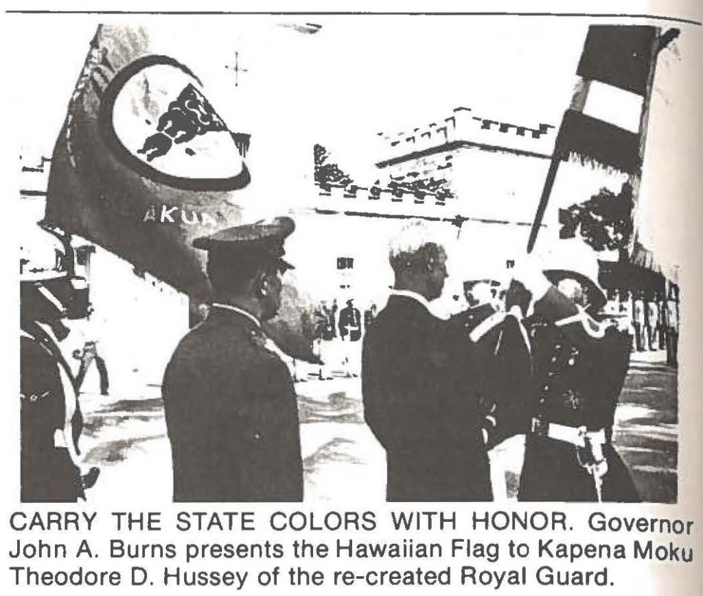 CARRY THE STATE COLORS WITH HONOR. Governor John A. Burns presents the Hawaiian Flag to Kapena Moku Theodore D. Hussey of the re-created Royal Guard.