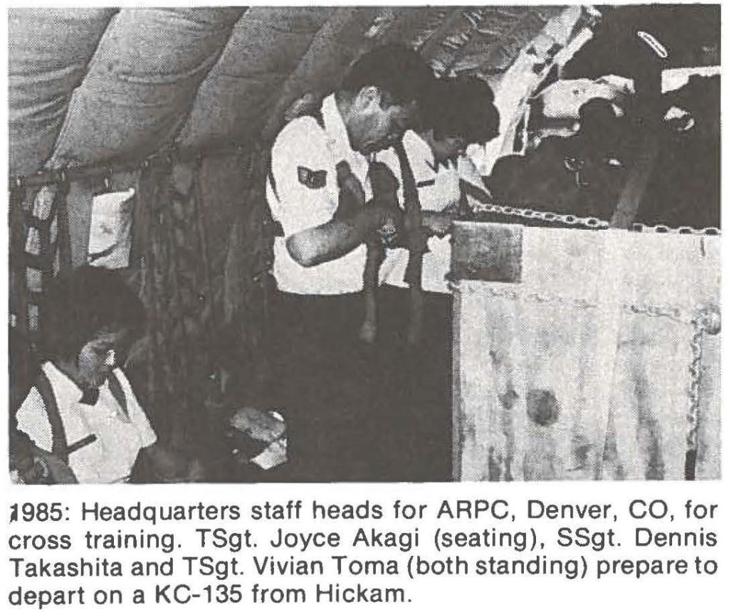 1985: Headquarters staff heads for ARPC, Denver, CO, for cross training. TSgt. Joyce Akagi (seating), SSgt. Dennis Takashita and TSgt. Vivian Toma (both standing) prepare to depart on a KC-135 from Hickam.