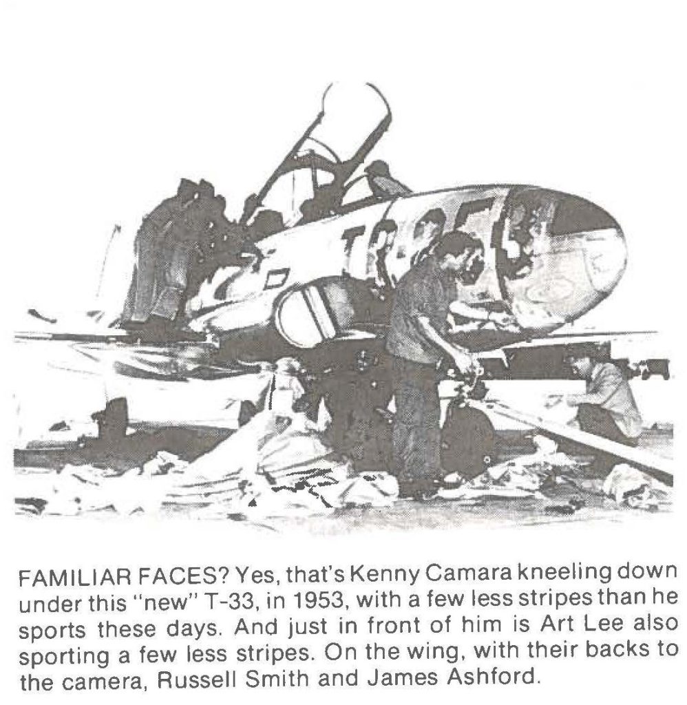 FAMILIAR FACES? Yes, that's Kenny Camara kneeling down under this "new" T-33, in 1953, with a few less stripes than he sports these days. And just in front of him is Art Lee also sporting a few less stripes. On the wing, with their backs to the camera, Russell Smith and James Ashford.