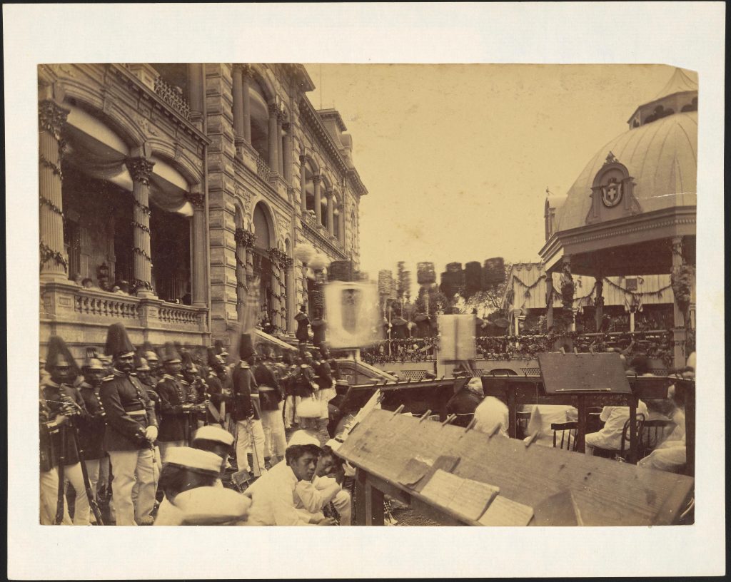 Coronation of King Kalakaua and Queen Kapiolani. Note walkway lined with kahili. Keywords- King Kalakaua, Coronation Title- Royal Household troops at Iolani Palace prior to coronation ceremony. Date- Feb. 12 1883