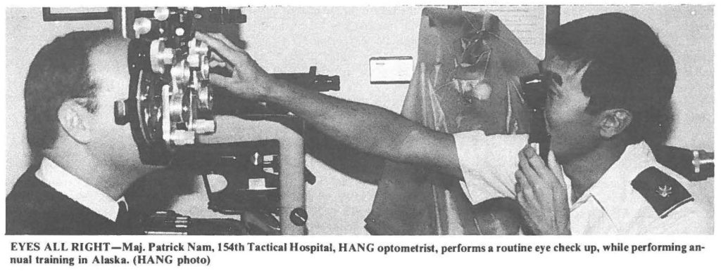 EYES ALL RIGHT-Maj. Patrick Nam. 154th Tactical Hospital, HANG optometrist, performs a routine eye check up, while performing annual training in Alaska. (HANG photo)