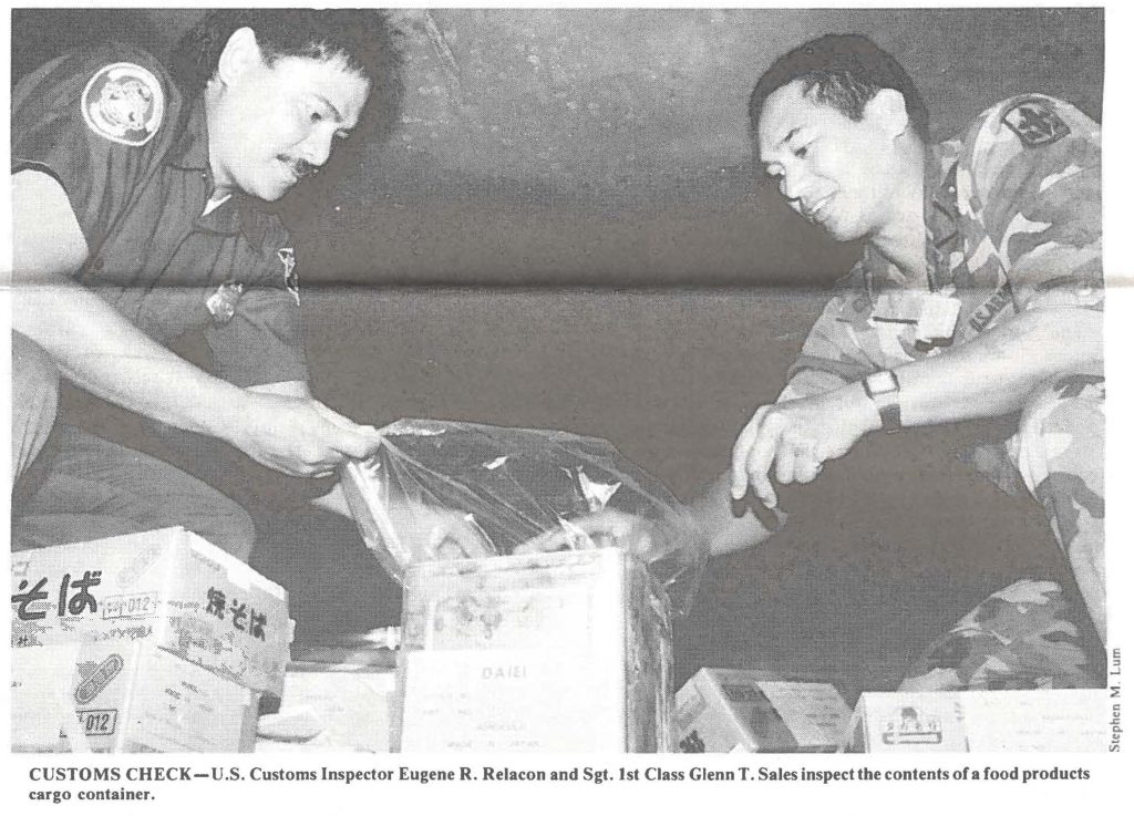 CUSTOMS CHECK-U.S. Customs Inspector Eugene R. Relacon and Sgt. 1st Class Glenn T. Sales inspect the contents of a food products cargo container.