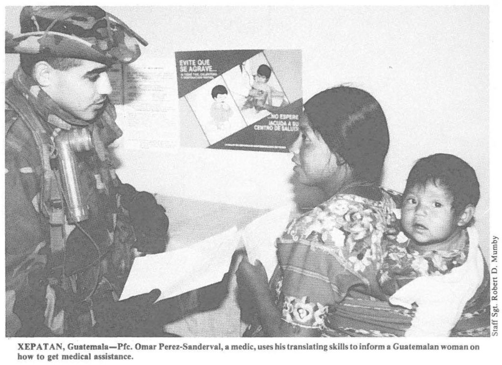 XEPATAN, Guatemala-Pfc. Omar Perez-Sanderval, a medic, uses his translating skills to inform a Guatemalan woman on how to get medical assistance.