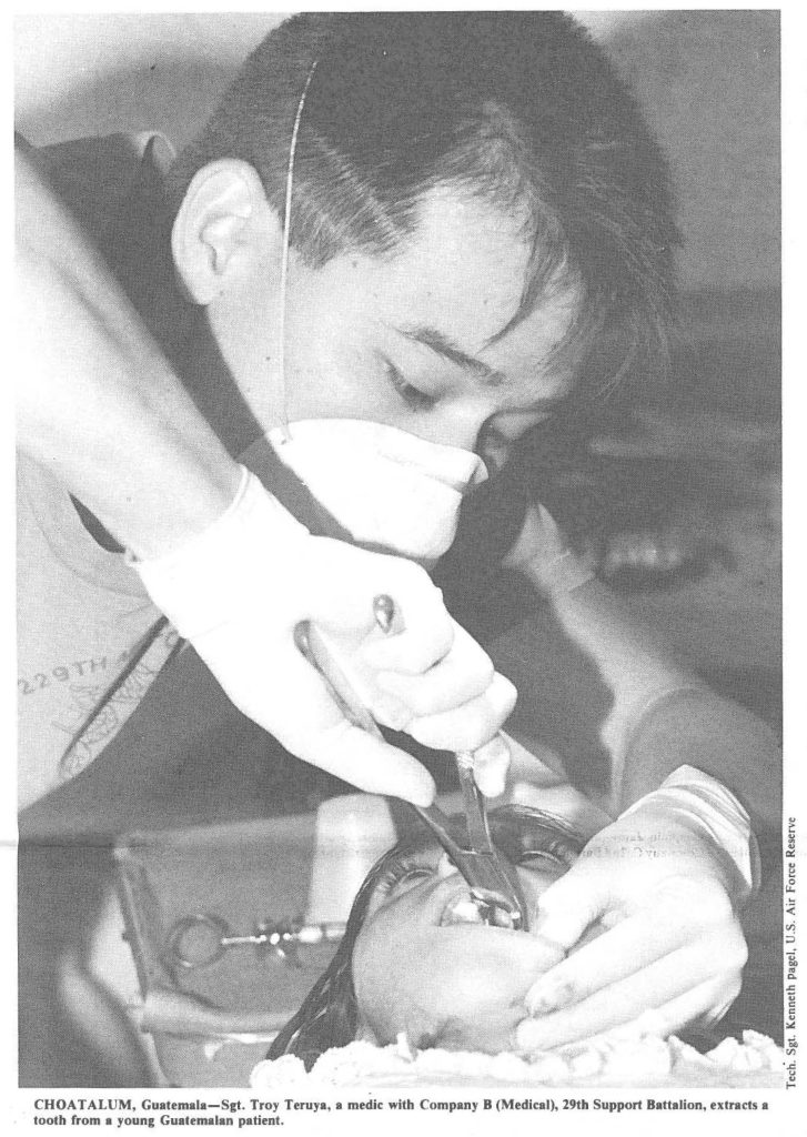 CHOAT ALUM, Guatemala-Sgt. Troy Teruya, a medic with Company B (Medical), 29th Support Battalion, extracts a tooth from a young Guatemalan patient.