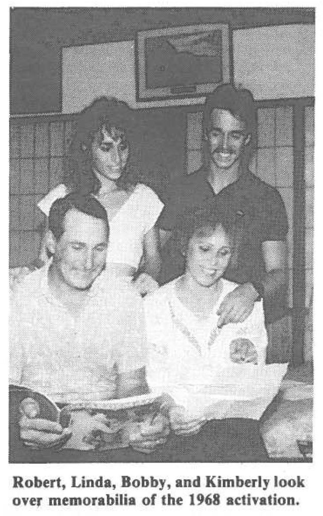 Robert, Linda, Bobby, and Kimberly look over memorabilia of the 1968 activation.