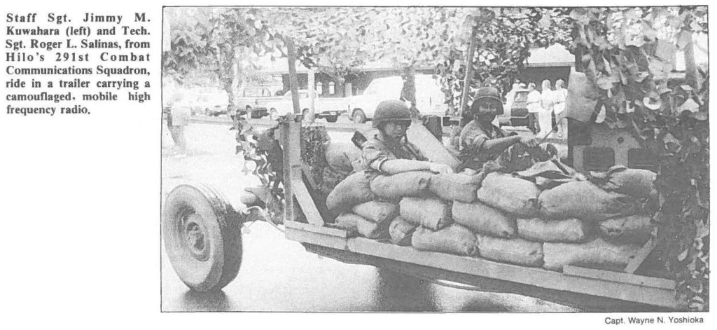 Staff Sgt. Jimmy M. Kuwahara (left) and Tech. Sgt. Roger L. Salinas, from Hilo's 291st Combat Communications Squadron, ride in a trailer carrying a camouflaged, mobile high frequency radio.