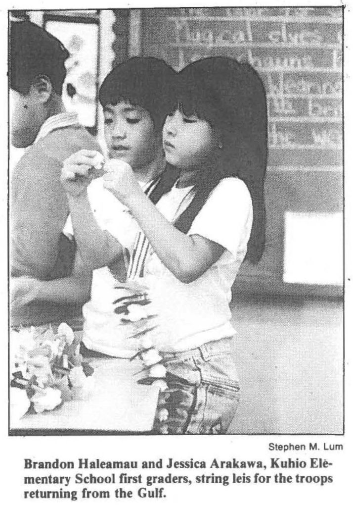 Brandon Haleamau and Jessica Arakawa, Kuhio Elementary School first graders, string leis for the troops returning from the Gulf.