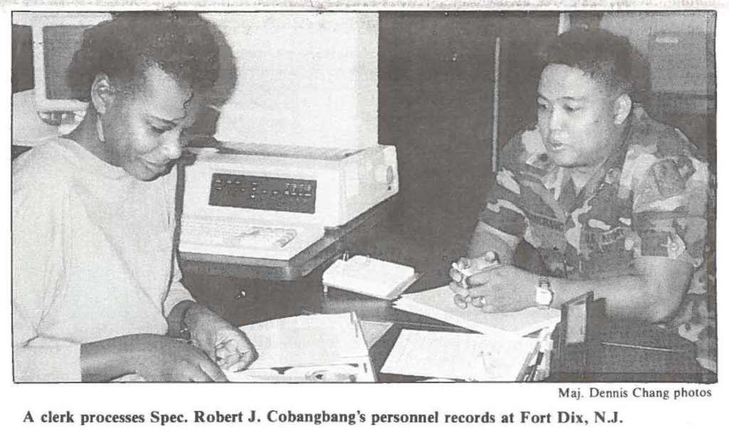 A clerk processes Spec. Robert J. Cobangbang's personnel records at Fort Dix, N.J.