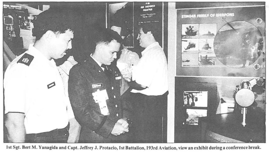 1st Sgt. Bert M. Yanagida and Capt. Jeffrey J. Protacio, 1st Battalion, 193rd Aviation, view an exhibit during a conference break.