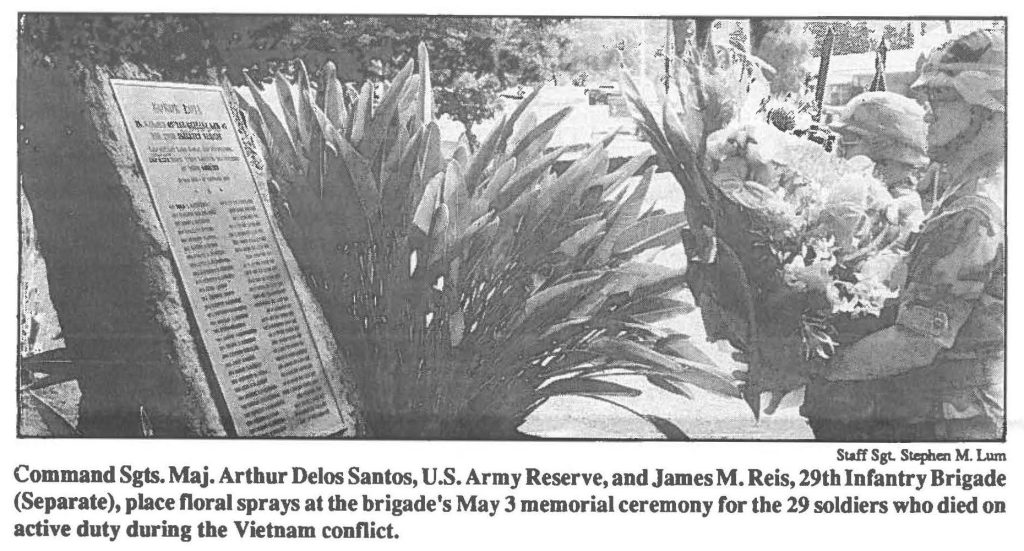 Command Sgts. Maj. Arthur Delos Santos, U.S. Army Reserve, and James M. Reis, 29th Infantry Brigade (Separate), place floral sprays at the brigade's May 3 memorial ceremony for the 29 soldiers who died on active duty during the Vietnam conflict.