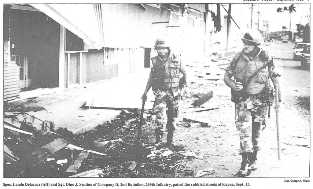 Spec. Lando Delacruz (left) and Sgt. Dino J. Sentino of Company D, 2nd Battalion, 299th Infantry, patrol the rubbled streets of Kapaa, Sept. 13.