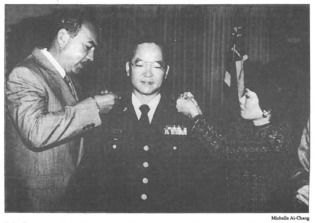 Brig. Gen. Eugene S. Imai, commander of the Hawaii Army National Guard, is pinned by Gov. John Waihee, commander in chief of the Hawaii Army National Guard, and Gen. Imai's wife, Gail, in the Governor's Chambers, March 18.