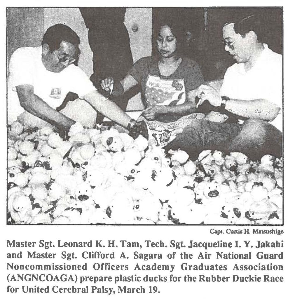 Master Sgt. Leonard K. H. Tam, Tech. Sgt. Jacqueline I. Y. Jakahi and Master Sgt. Clifford A. Sagara of the Air National Guard Noncommissioned Officers Academy Graduates Association (ANGNCOAGA) prepare plastic ducks for the Rubber Duckie Race for United Cerebral Palsy, March 19.