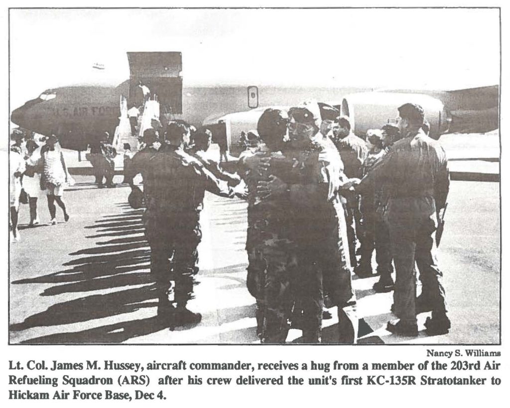 Lt. Col. James M. Hussey, aircraft commander, receives a hug from a member of the 203rd Air Refueling Squadron (ARS) after his crew delivered the unit's first KC-135R Stratotanker to Hickam Air Force Base, Dec 4.