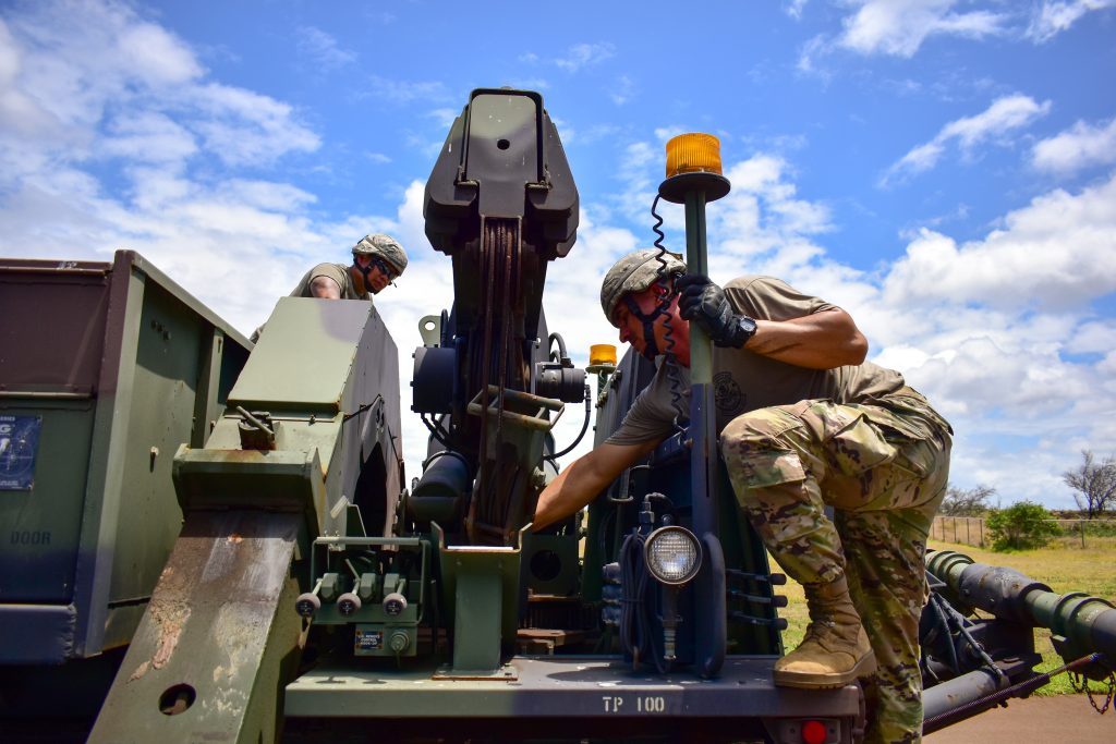Staff Sgt. Richard Akana and Sgt. Raymond Domingo, both Wheeled Vehicle Mechanics with Bravo Company, 1109th Theater Aviation Sustainment Maintenance Group, 103rd Troop Command, Hawaii Army National Guard work together to troubleshoot and repair a Heavy Expanded Mobility Tactical Truck on the island of Maui during COVID-19 operations, Kihei, Hawaii, May 9, 2020. (U.S. Army National Guard photo by Sgt. 1st Class Theresa Gualdarama)