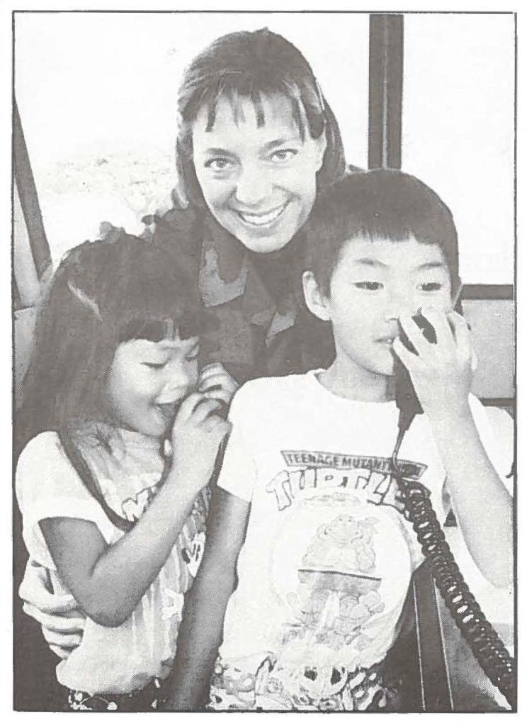 NO COMMUNICATION BARRIER - -Tech. Sgt. Denise Jelinski-Hall, of Aiea, lets Debbie Chow, 5, and Jason Chow, 6, of Kaimuki, try out Hawaii Air National Guard (HIANG) mobile air traffic control tower band sets. Jelinski-Hall, a controller with the HIANG's 297th Air Traffic Control Squadron, stationed at Barbers Point Naval Air Station, works full-time as an administrative assistant with a financial planner.