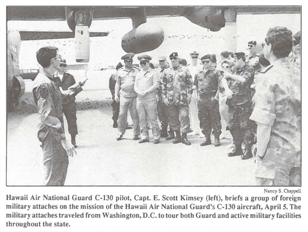 Hawaii Air National Guard C-130 pilot, Capt. E. Scott Kimsey (left), briefs a group of foreign military attaches on the mission of the Hawaii Air National Guard's C-130 aircraft, April 5. The military attaches traveled from Washington, D.C. to tour both Guard and active military facilities throughout the state.