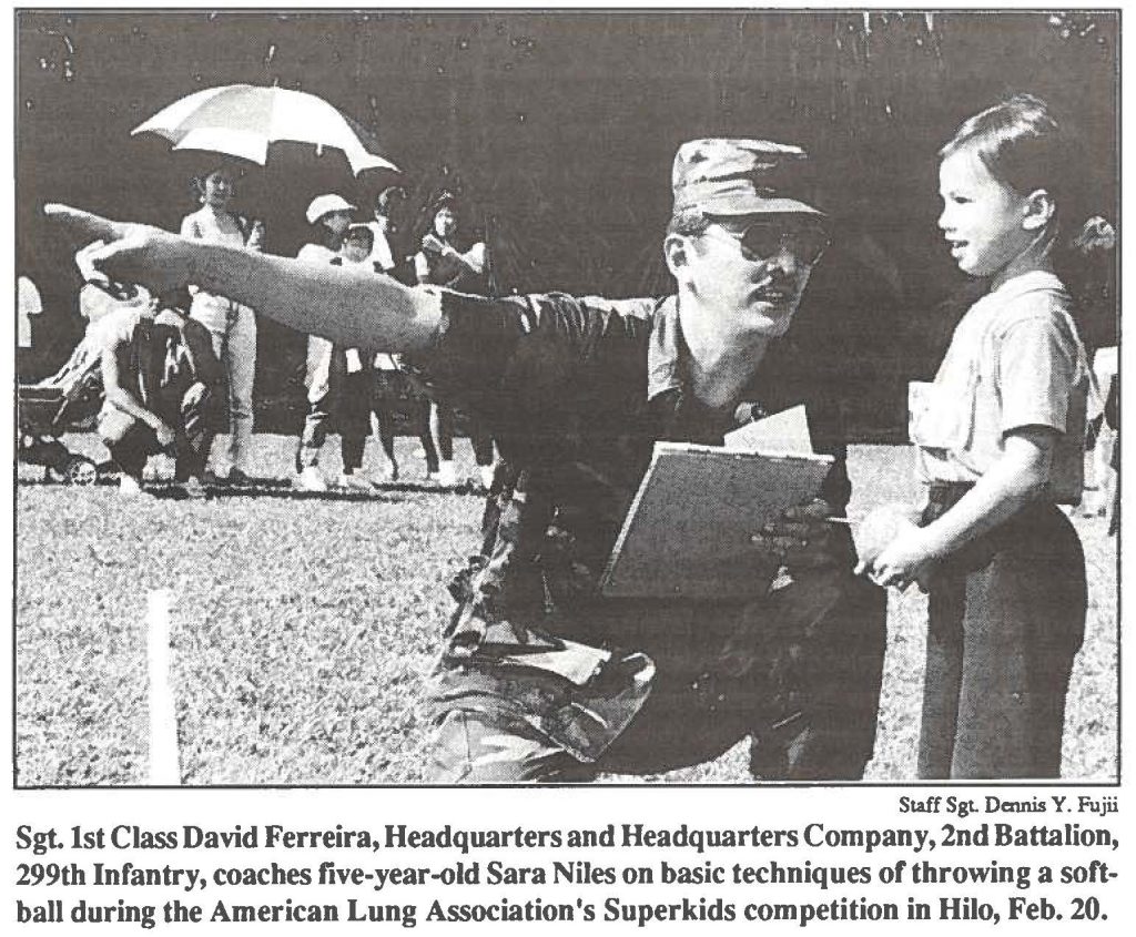 Sgt.1st Class David Ferreira, Headquarters and Headquarters Company, 2nd Battalion, 299th Infantry, coaches five-year-old Sara Niles on basic techniques of throwing a softball during the American Lung Association's Superkids competition in Hilo, Feb. 20.